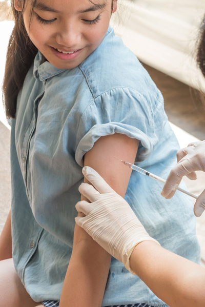 young girl getting a vaccine